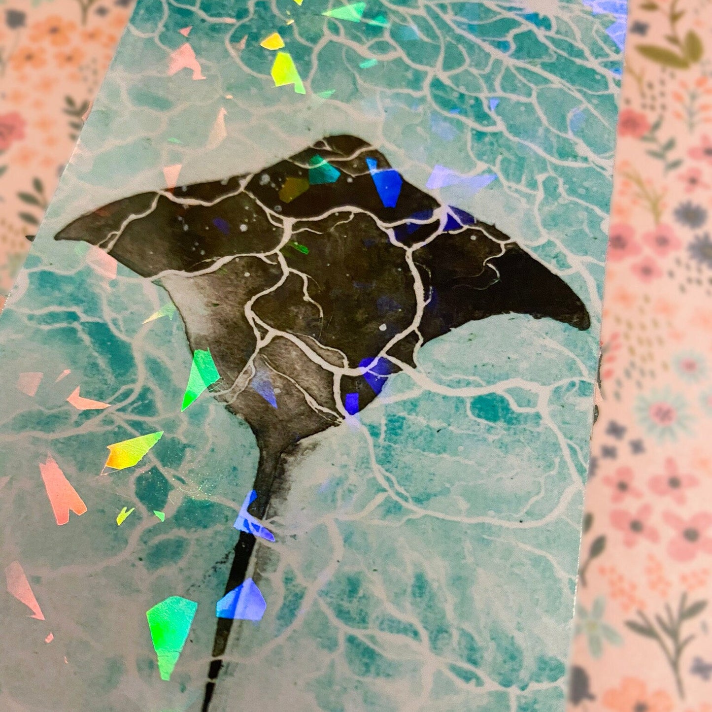 Aesthetic ray bookmark swimming under blue water surface.Side view