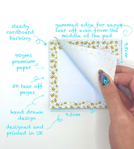 Hand holding a square lemon themed memo pad with features highlighted on a white background