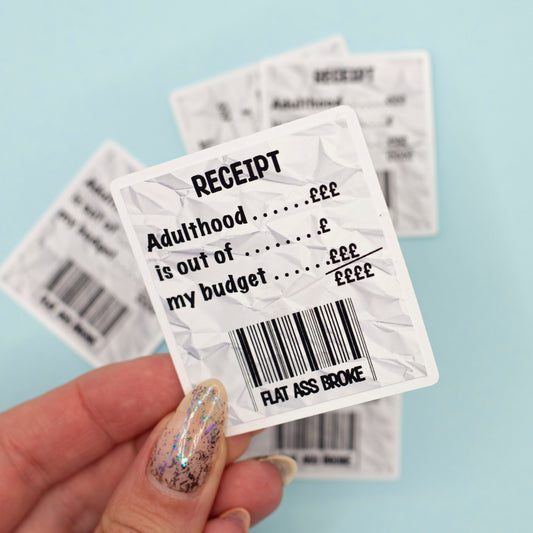 A crumpled white receipt-style sticker with black text reading 'RECEIPT Adulthood is out of my budget flat ass broke'.