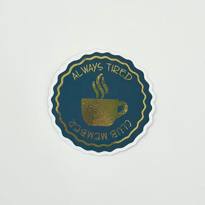 aestetic sticker with a coffee cup design and text 'Always Tired Club Member' with gold details on white background. Top View
UK Small shop
