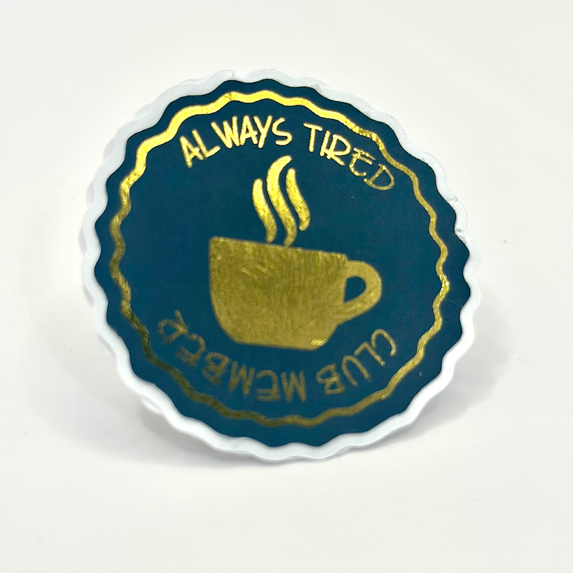 Aestetic sticker with a coffee cup design and text 'Always Tired Club Member' with gold details on white background. side View
UK small shop