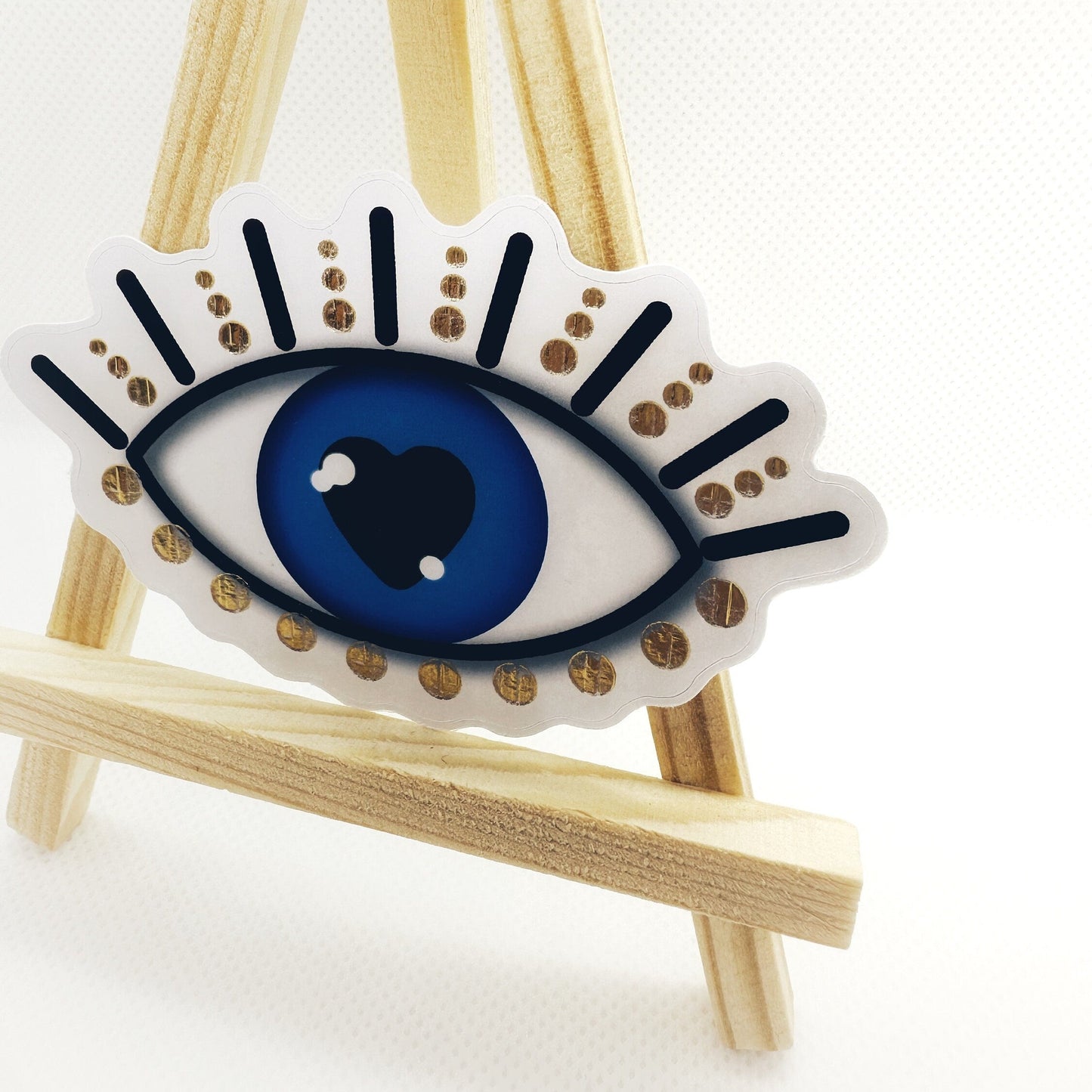 Evil eye sticker with gold details. side view