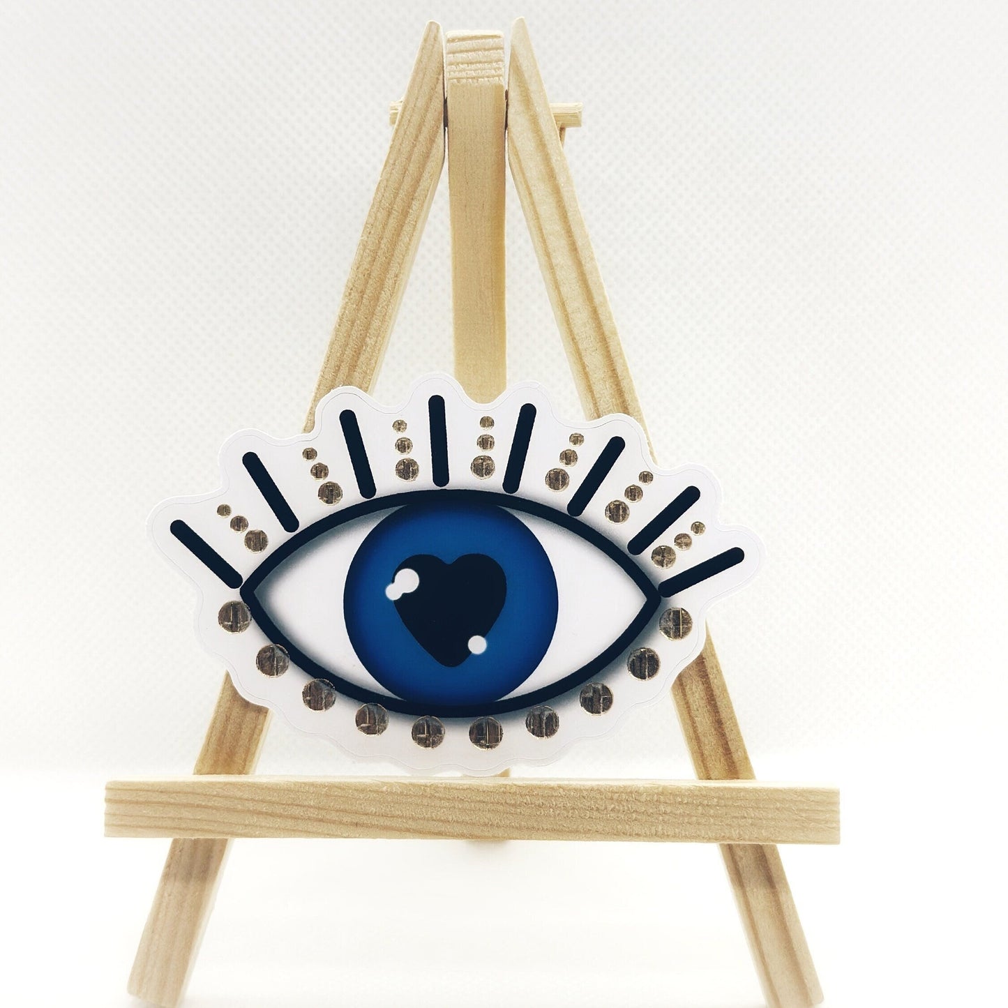 Evil eye sticker with gold details. Frontal view