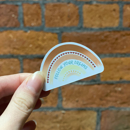 Aesthetic color rainbow sticker with 'follow your dreams' text. Frontal