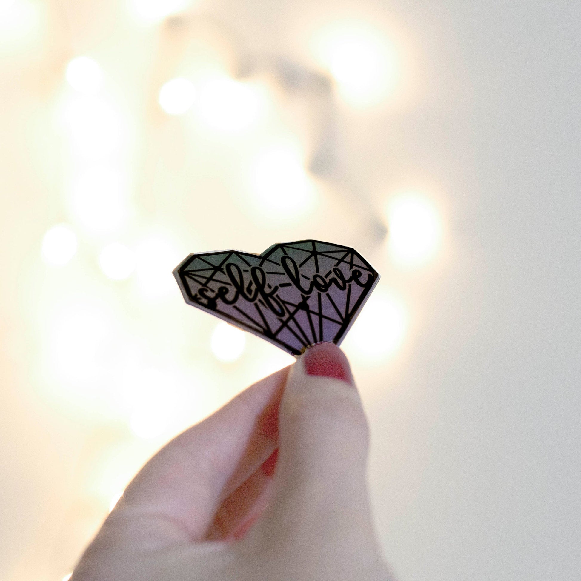 Holographic aesthetic self love heart sticker. Angle view