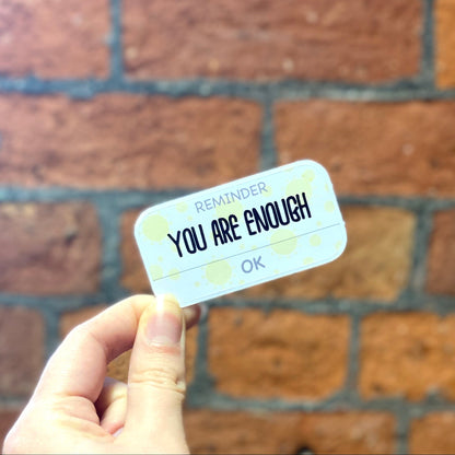 Matte aesthetic motivation sticker with text 'reminder you are enough'. Frontal view