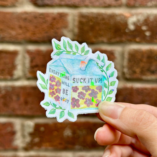 Holographic motivation sticker resempling juice cartoon with text 'suck it up! everything will be okay' and floral motives. Frontal