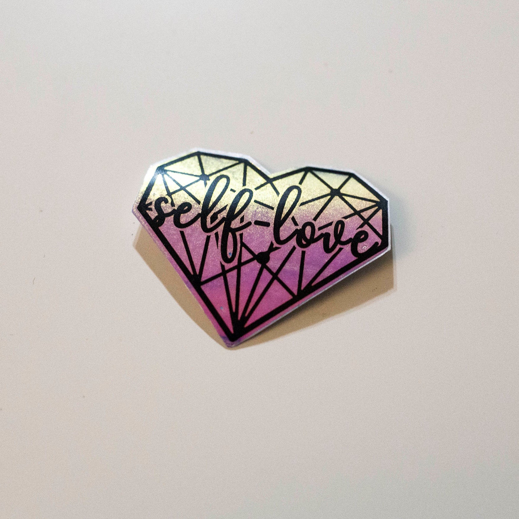 Purple holographic aesthetic self love heart sticker. Top view