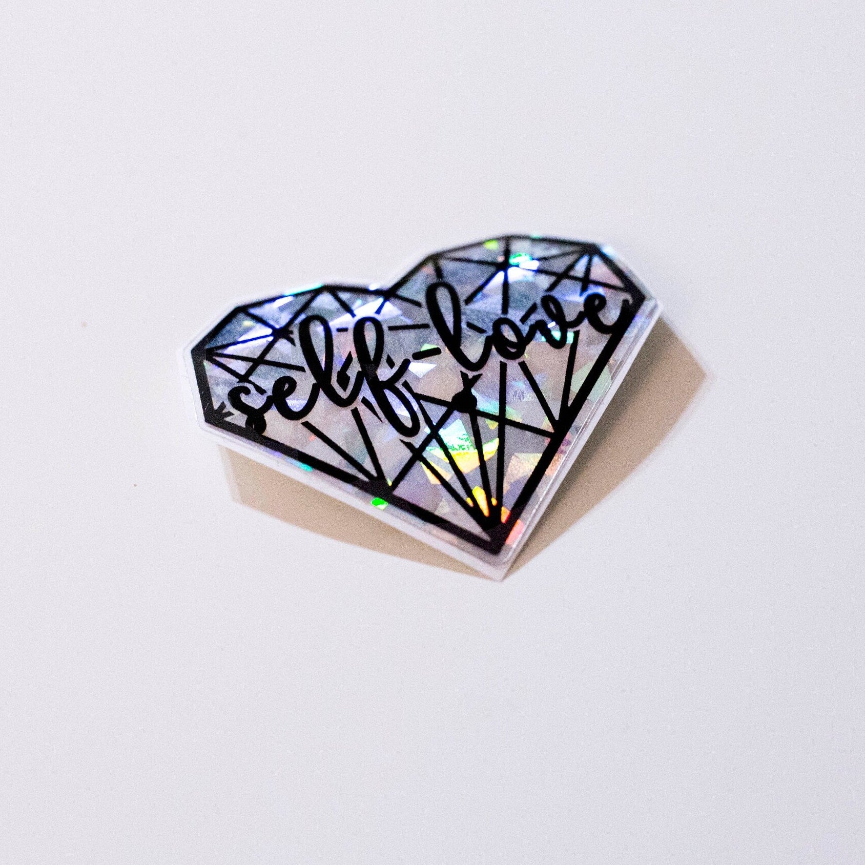 silver broken glass aesthetic self love heart sticker. side view