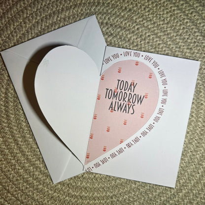 Heart-shaped card with 'Today Tomorrow Always' text on a textured surface