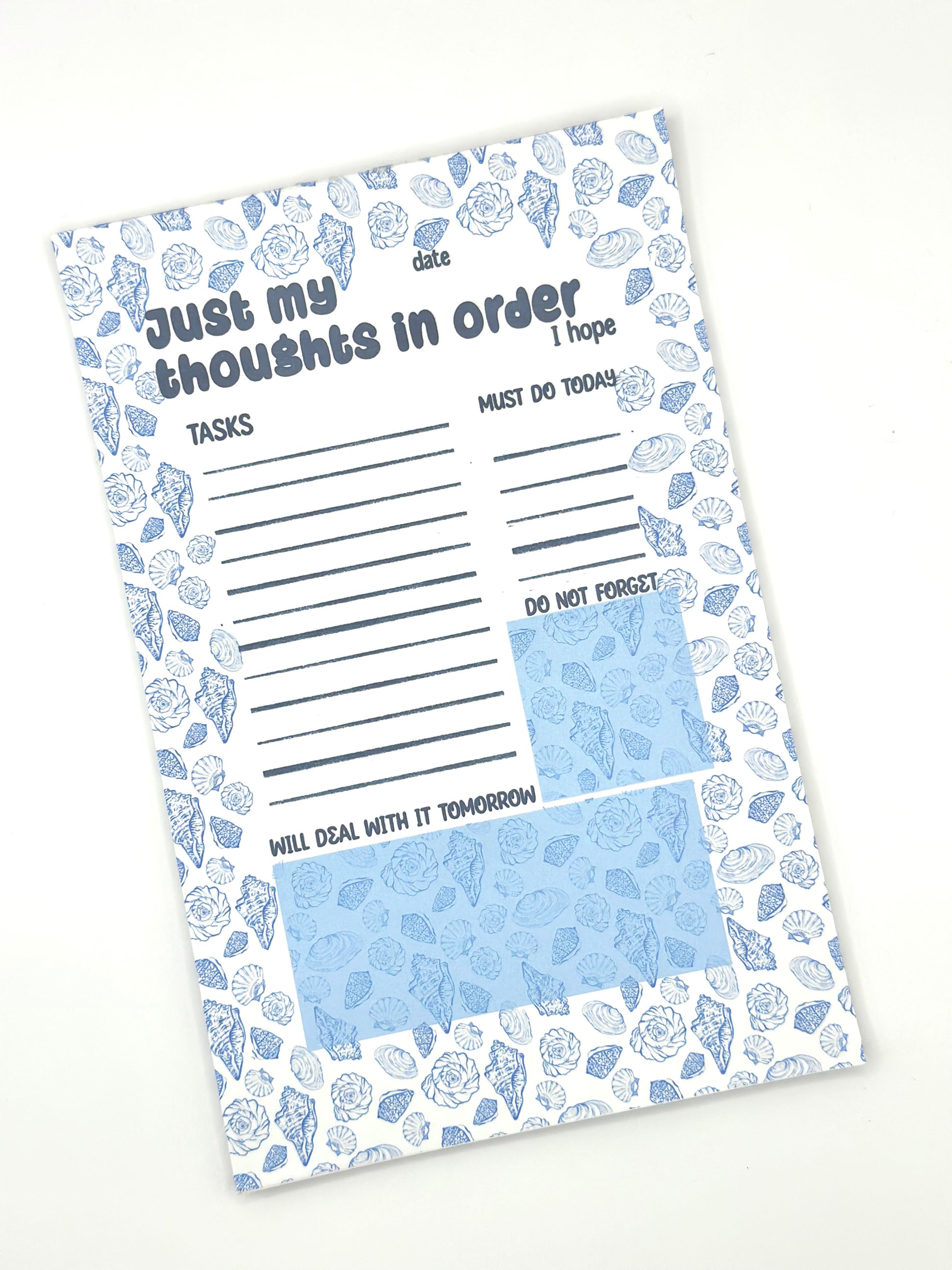 Notepad with coastal design and text 'Just my thoughts' on a white background