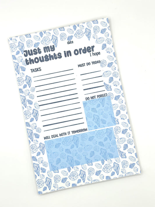 Notepad with coastal design and text 'Just my thoughts' on a white background