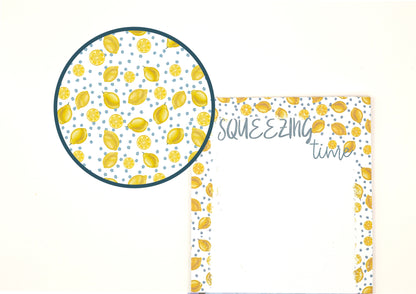A notepad with a lemon pattern border on a white background, featuring a circular magnified inset showing the detailed lemon pattern.