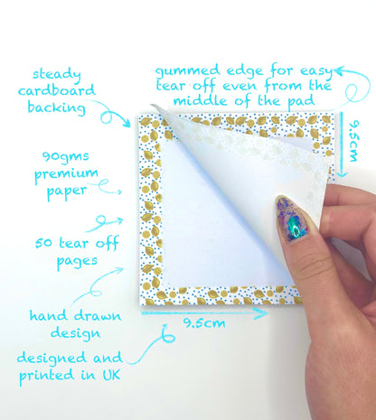 Hand holding a square lemon themed memo pad with features highlighted on a white background