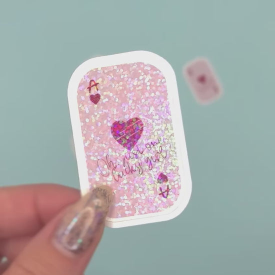  a small rectangular ace card sticker with rounded corners. The card has a light pink background with holographic dot overlay with a red heart, the letter A, and the phrase 'Oh my one lucky girl' in pink script.
