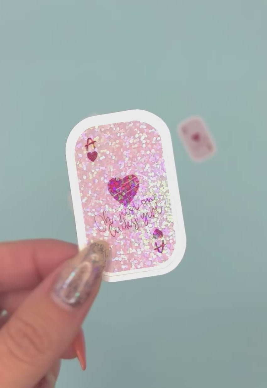  a small rectangular ace card sticker with rounded corners. The card has a light pink background with holographic dot overlay with a red heart, the letter A, and the phrase 'Oh my one lucky girl' in pink script.