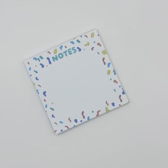 showcasing square memo pad with confetti design