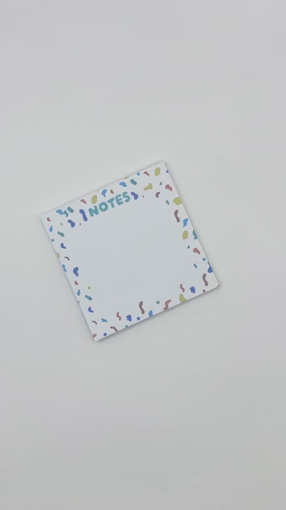 showcasing square memo pad with confetti design