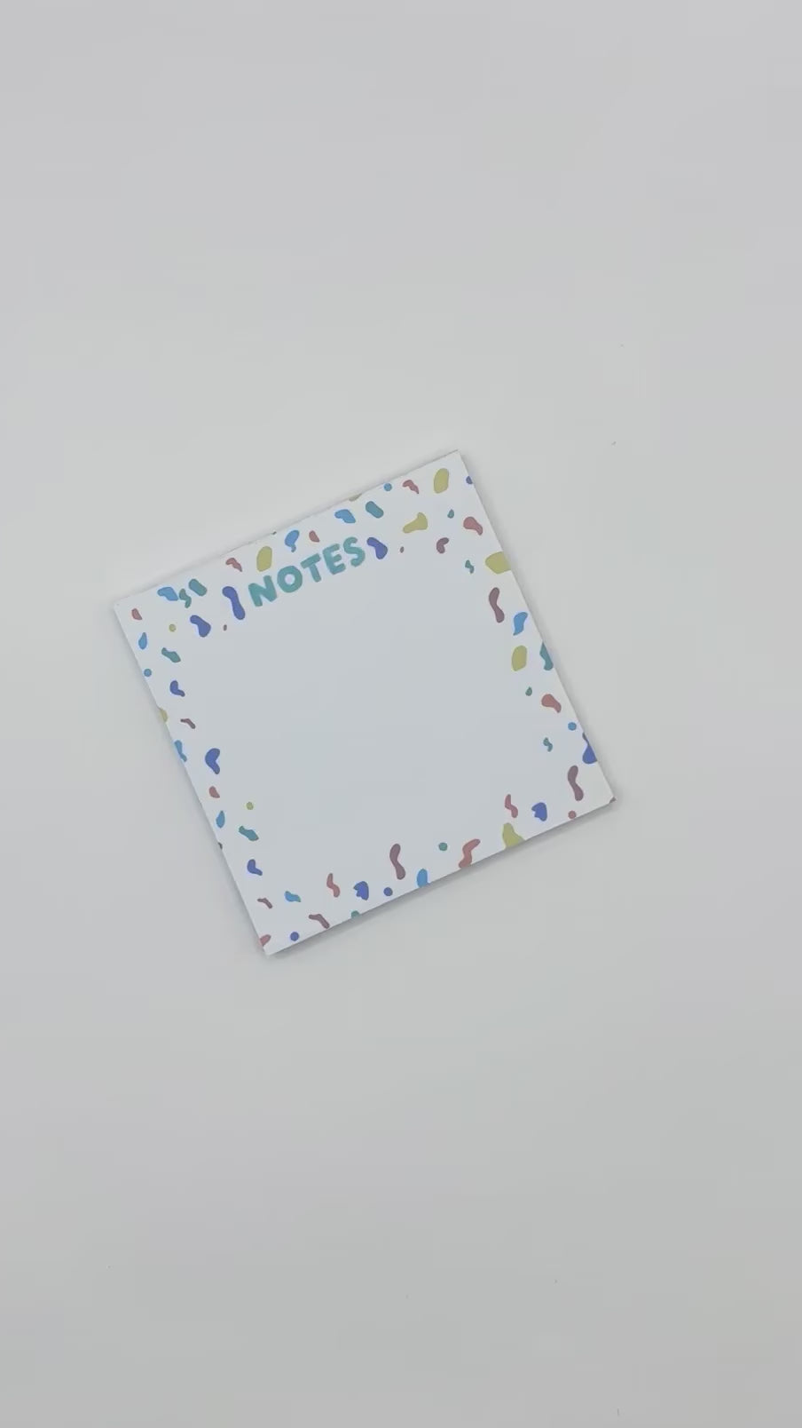 showcasing square memo pad with confetti design