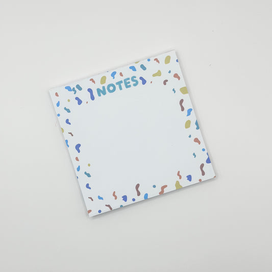 square memo pad with colorful text 'NOTES' and confetti border on a white  background