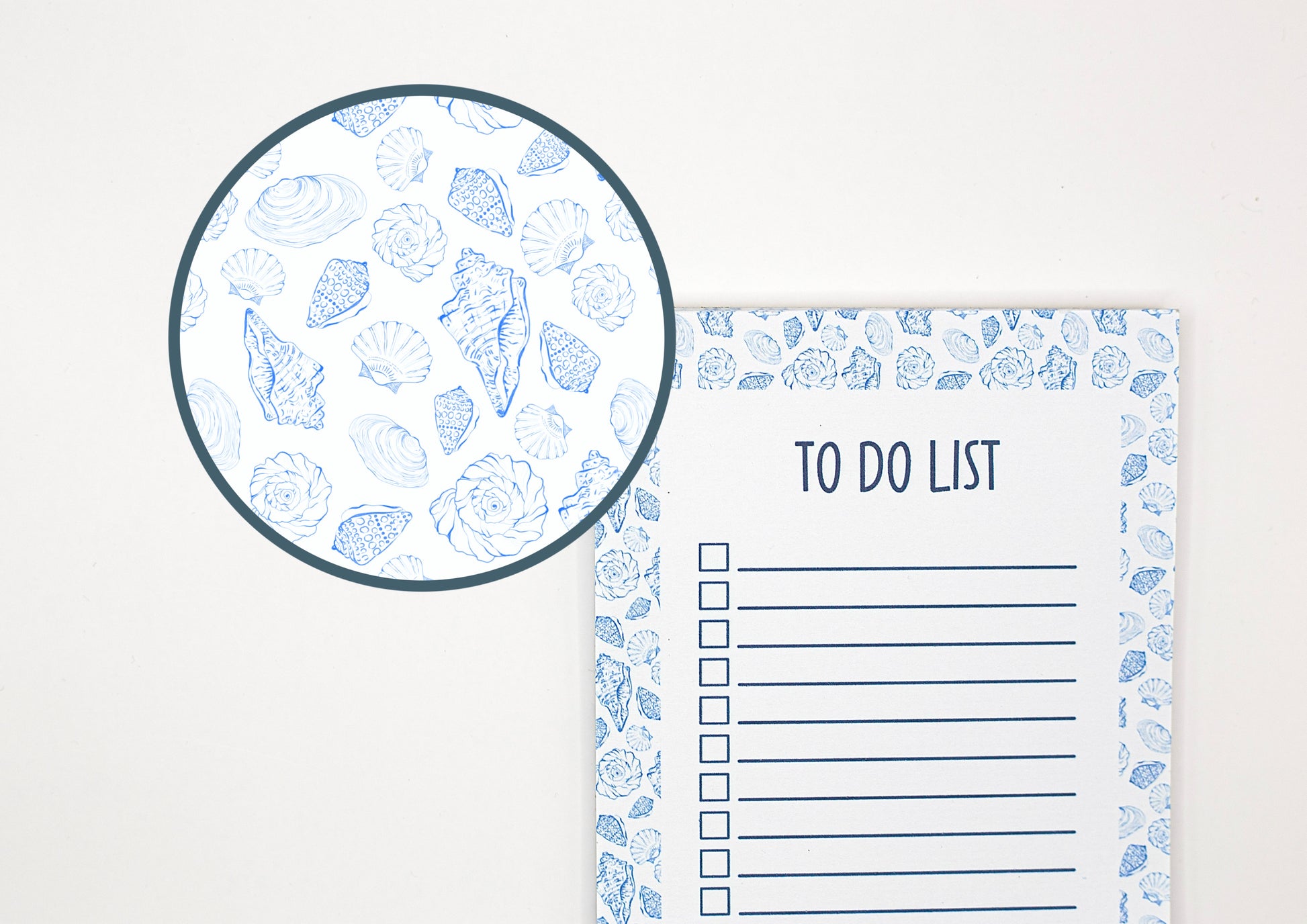 A white to-do list pad with a blue seashell pattern border, shown next to a circular close-up inset of the matching seashell pattern.